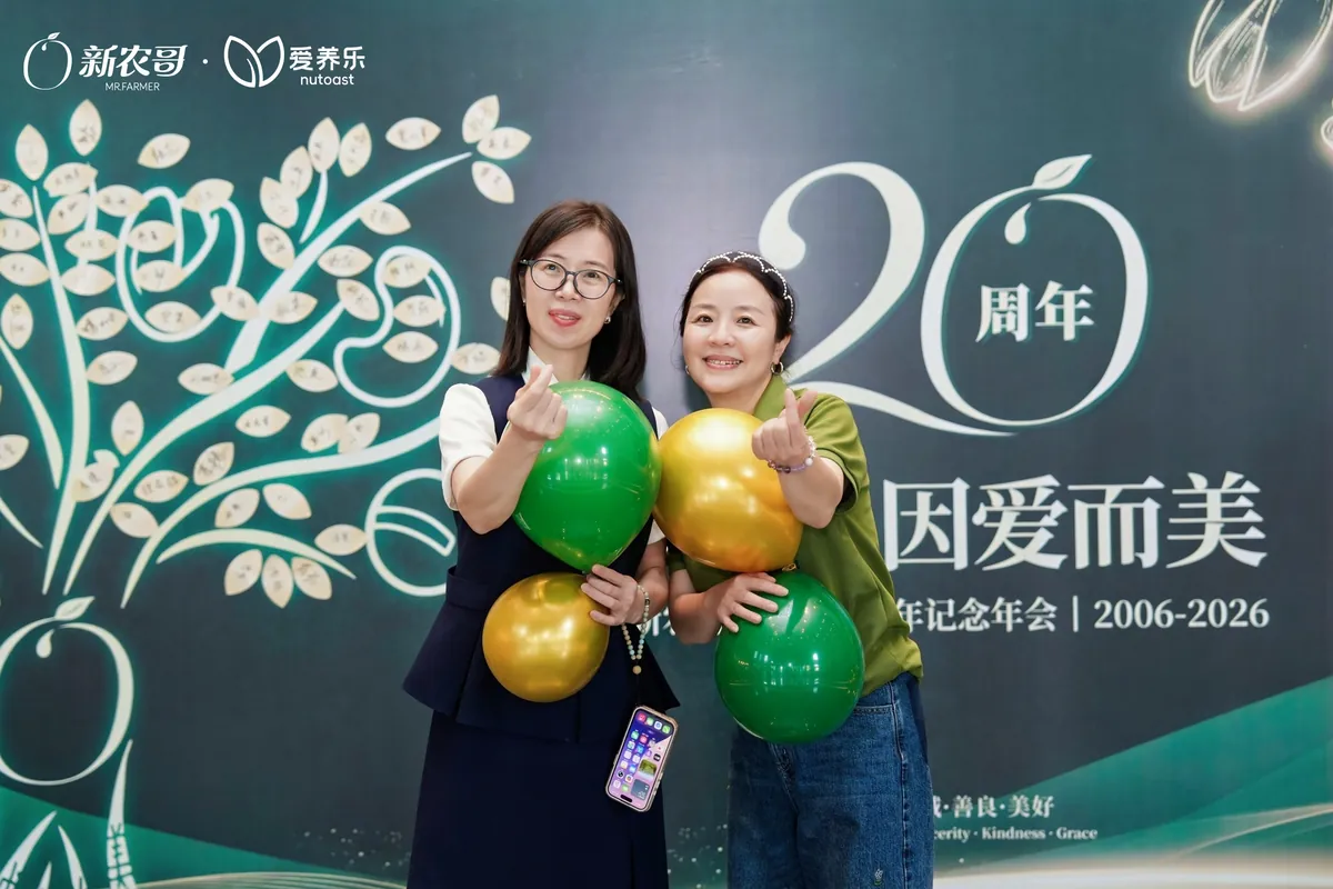 Colleagues at the anniversary photo wall.