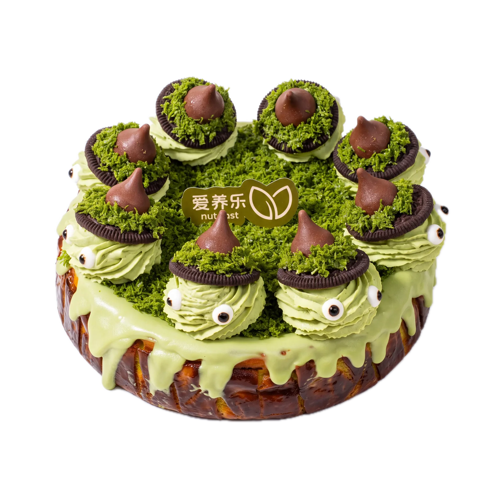 Pistachio Basque cheesecake from above, topped with piped monster faces in Oreo witch hats